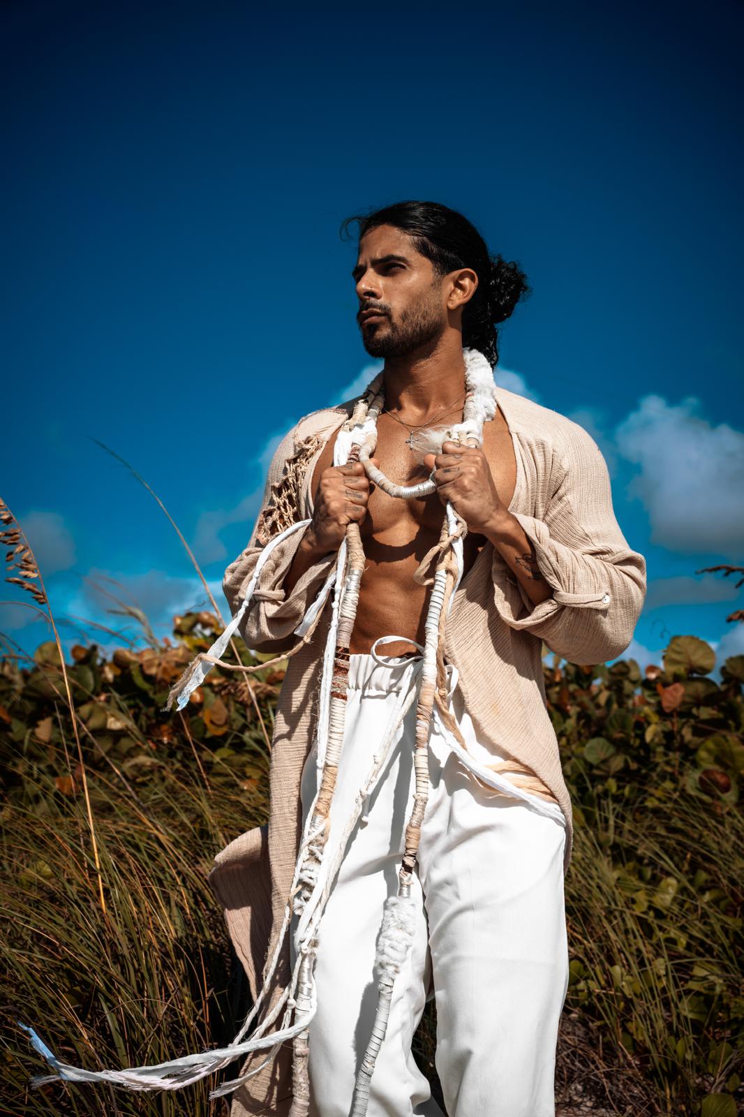 Male model in a linen open robe against a Miami blue sky