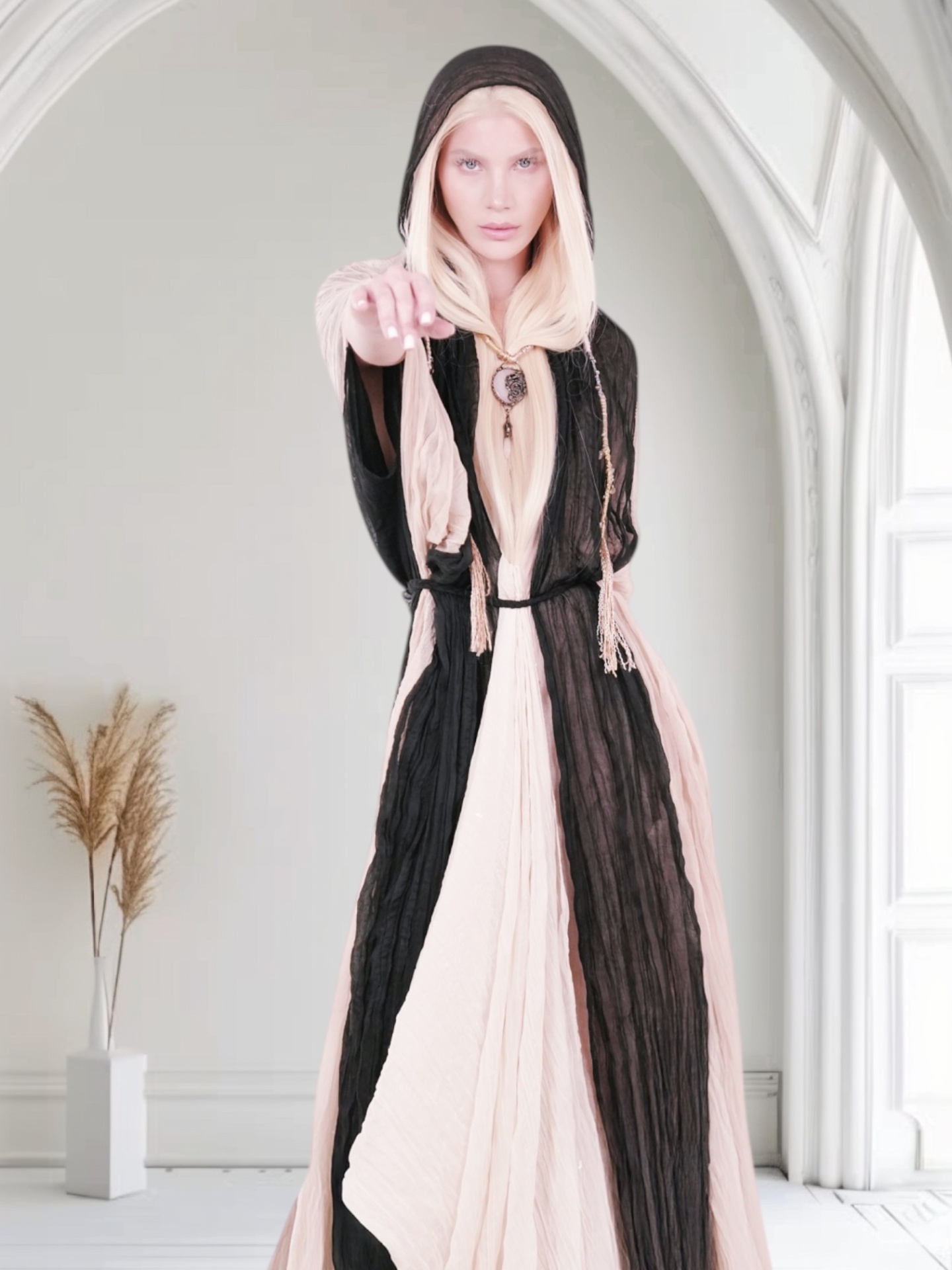 Model wearing a hooded artisan garment